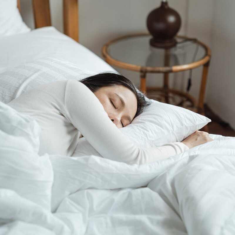 Young woman sleeping in comfy bed